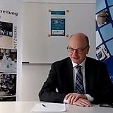 Person an einem Schreibtisch liest ein Dokument