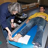 Person lässt ihre Füße von einem Gerät überprüfen